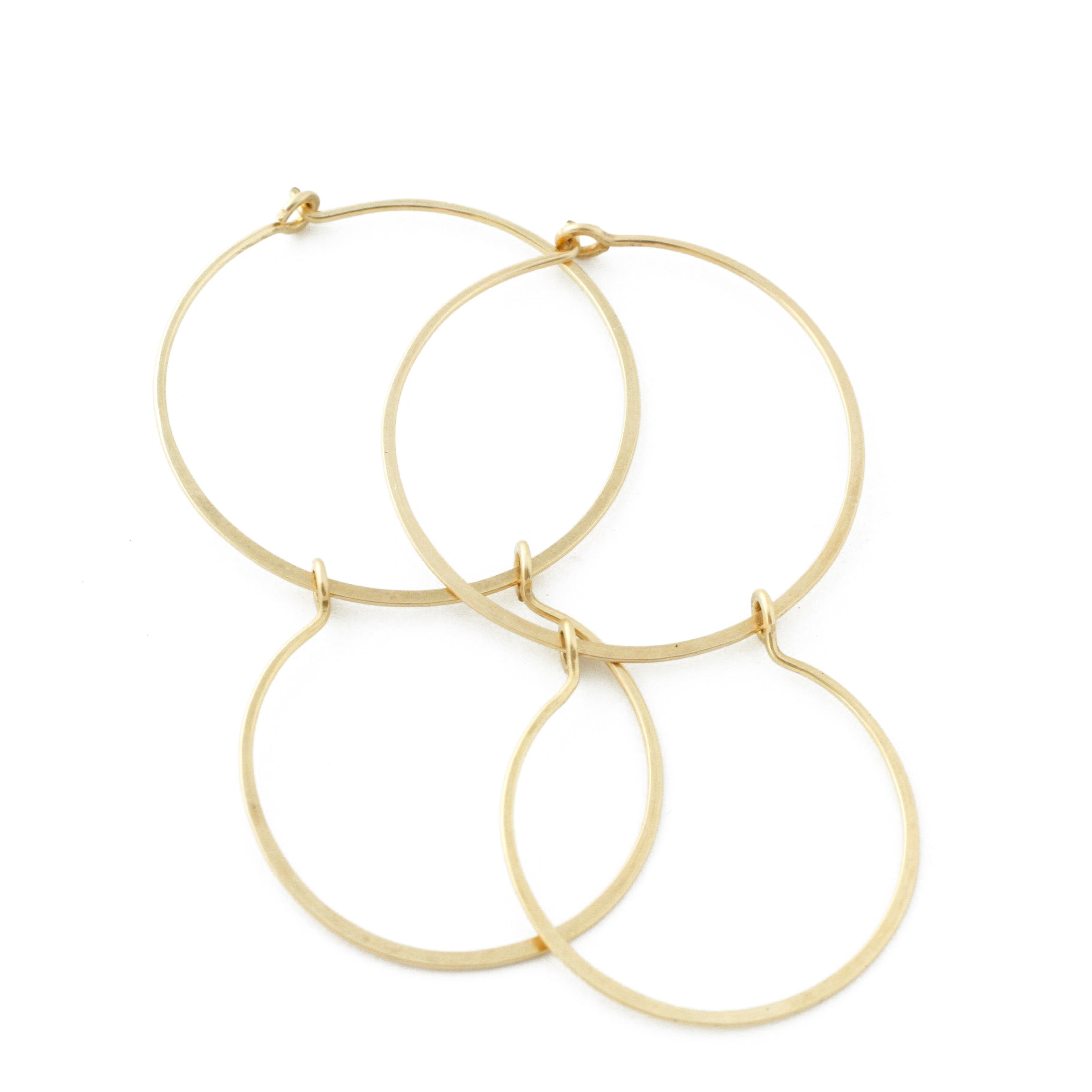 Double hoop earrings in gold-filled with a white background.